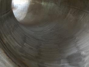 Failing basalt lining removed and steel pipe bend grit blasted Failing basalt lining removed and steel pipe bend grit blasted